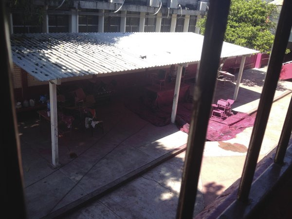 A view of an employee spray painting the metal desks for the upcoming school year at Escuela Josefa Ortiz De Domingue in Culican, Sinaloa, Meixco